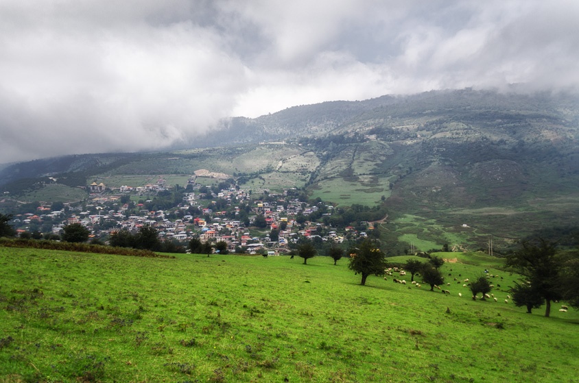 houses in valley under clouds