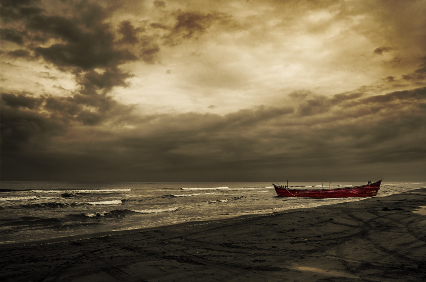 lonely boat on the beach of behshahr